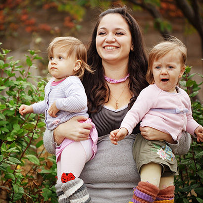 A mother holding her children.