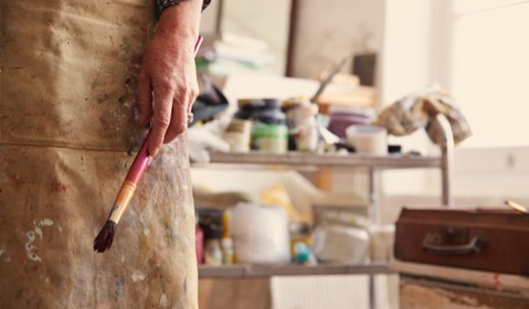 An artist holding a brush.