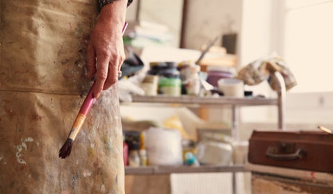 An artist holding a brush.
