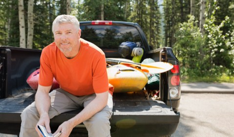 A person storing out door equipment in his car. 