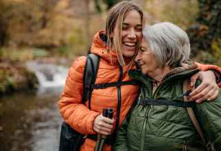 Mother and daughter laughing in nature