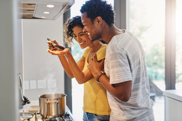 A couple cooking together.