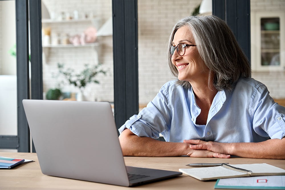 A person happily working on their laptop.