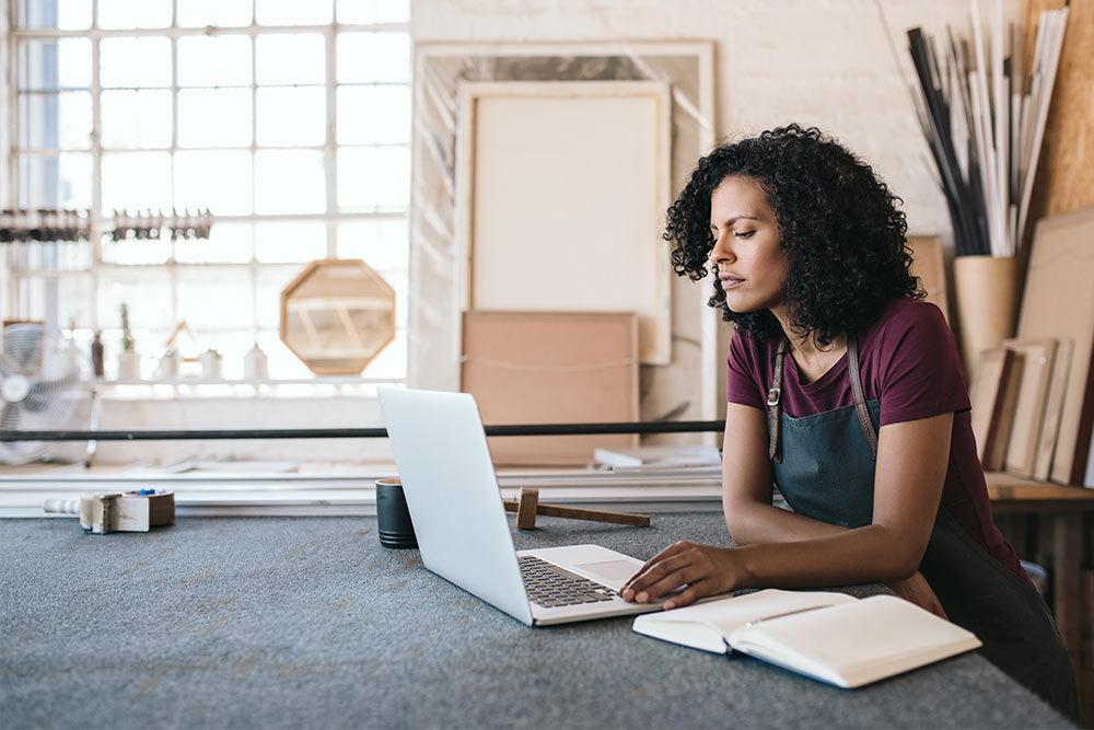 A woman working on a laptop.