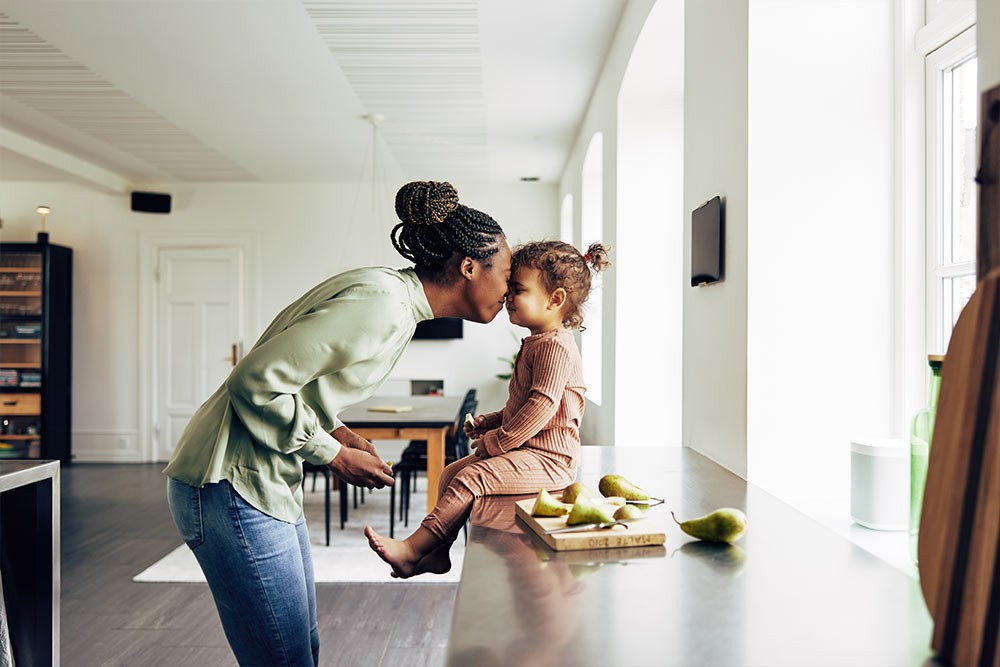 A mother and daughter sharing some fruits.